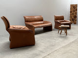 COGNAC LEATHER SEATING GROUP ARMCHAIR SOFA OTTOMAN IM THE STYLE OF DE SEDE, 1980s